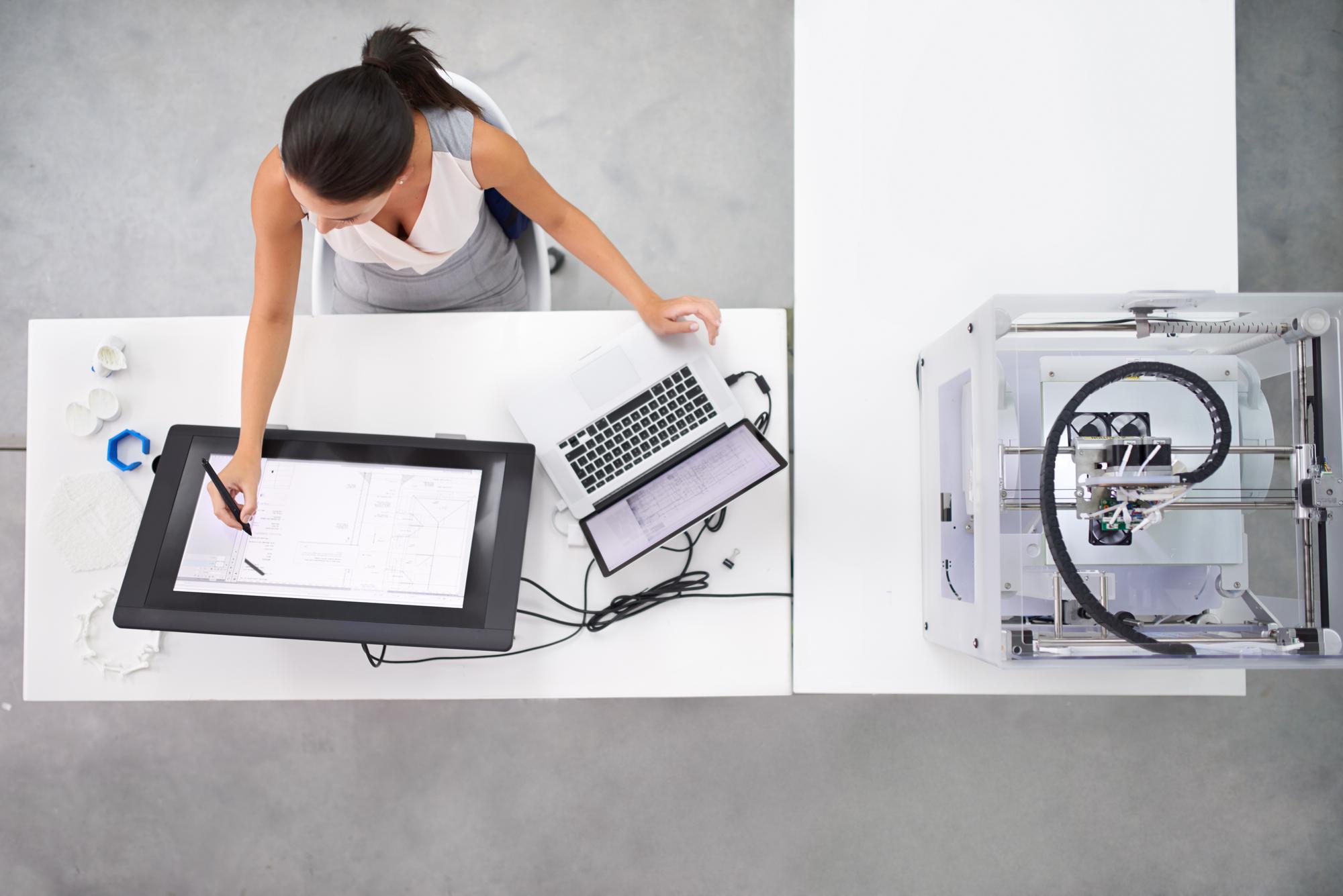 studio contact desk with embroidery sample and laptop